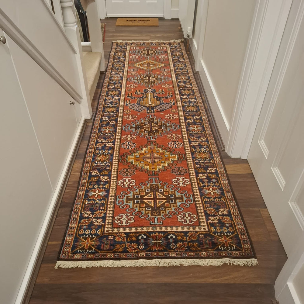 Decorative runner rug on a wooden floor in a hallway