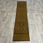 Handmade Afghan brown Mushwani tribal runner rug featuring a textured combination of flat-weave kilim and raised wool pile geometric diamond patterns, running along a light oak wood floor