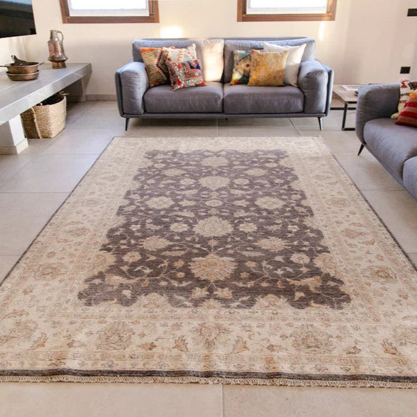 Living room with an Afghan Ziegler rug, gray sofa, and decorative pillows.