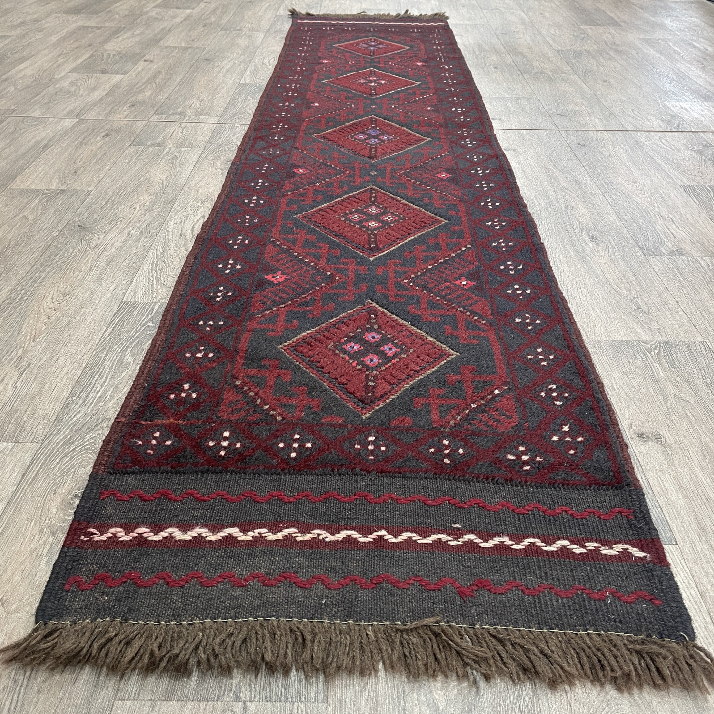 mushwani runner with geometric pattern on a wooden floor